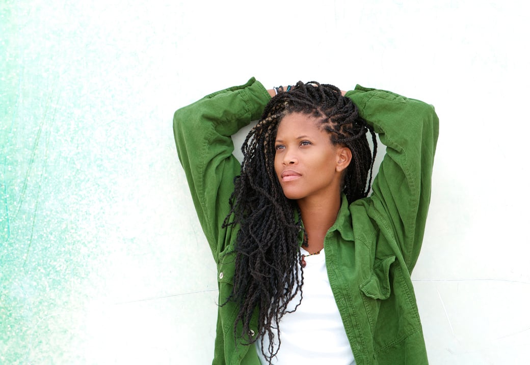 Portrait of a Woman in Dreadlocks Wearing a Green Jacket